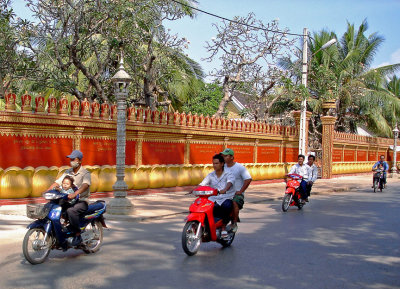 Motorbikes passing Wat Preah Prom Rath