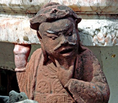 Red stone sculpture of a Chinese man