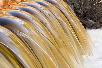 Water flowing over Butler Creek dam