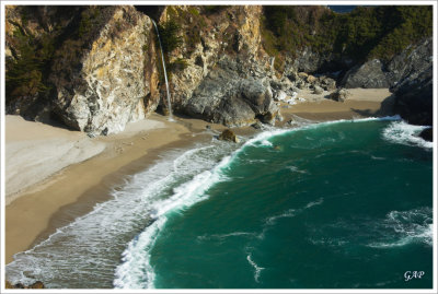 80-foot waterfall dropping from cliffs into the ocean