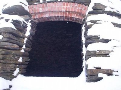 A window in the back wall of the kiln, looking in from outside.