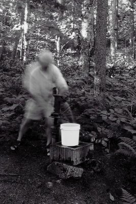Self-Portrait with Hand Pump and White Bucket