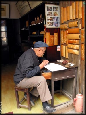 A man is practising calligraphy