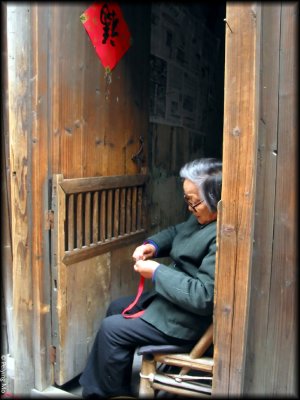 A lady is making some handicrafts for sale