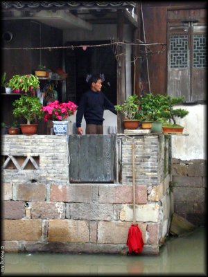 A man exercises on his small balcony