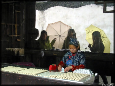 A young girl is making some traditional snacks