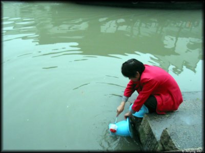 A woman is cleaning a urine bucket
