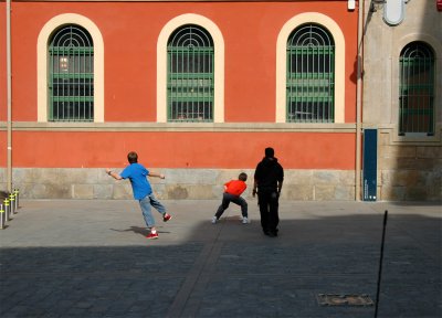 Playing pelota in the wall of the market