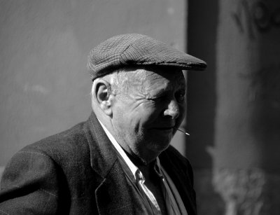 Man with cap and toothpick
