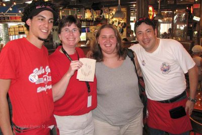 Susan and Heidi with Hector and Alex, waiters from Bubba Gump