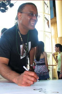 Fred signs poster for Gloria
