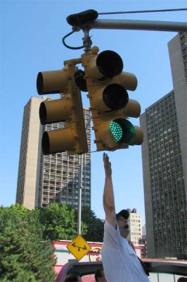 Tour guide swings stop light