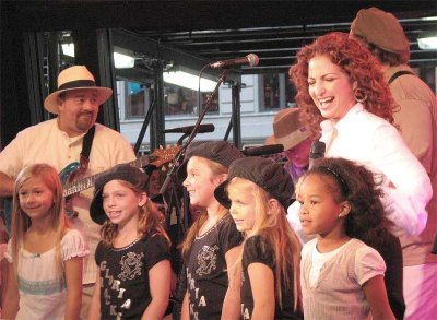 A group of pageant queens join Gloria on stage
