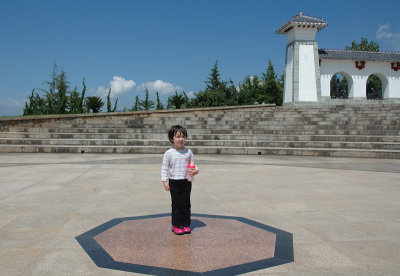 Emma Standing in the Center of a Plaza