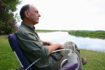 John contemplates the meaning of life with a beer at Shakawe Lodge, Botswana