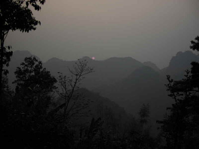 A smoky sunset on Doi Ang Khang looking towards Myanmar