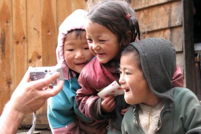Nepali kids intrigued by a Canon digital camera
