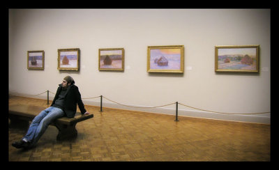 a guy in front of Monet's paintings