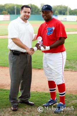 Chris Allen, COO of the South Coast League, presents Ismael Castro with the Peach State Series MVP award.