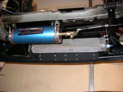 Accusump mounted under radiator cross-member.