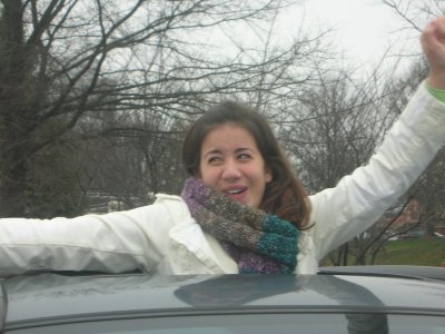 haha out the sunroof of her car