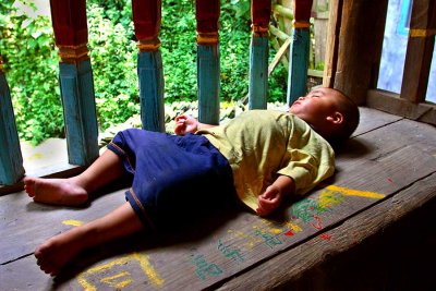 1061 Child sleeping in a drum tower.