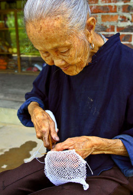 0293 Village elder making netting.