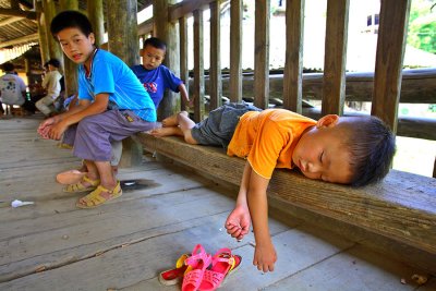 3541 Sleeping child on wind rain bridge at north section of village close to the new drum tower.