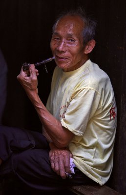 4417 Kam elder relaxing and smoking his pipe.