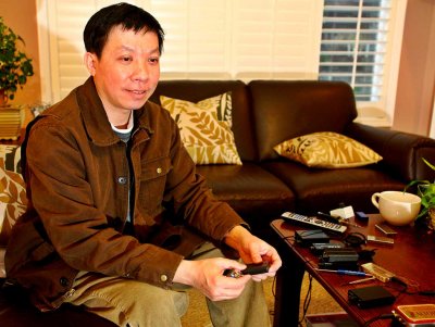 Dr. Xin Feng holding holding two of his creations the Micro IV and Mini IV headphone amplifiers.