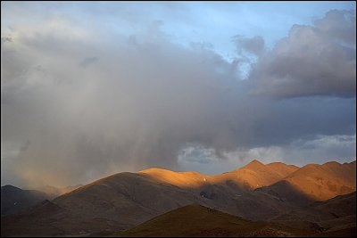 sun lit mountain in the storm
