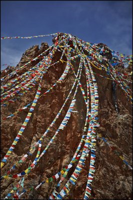 praying flags descending from the hill