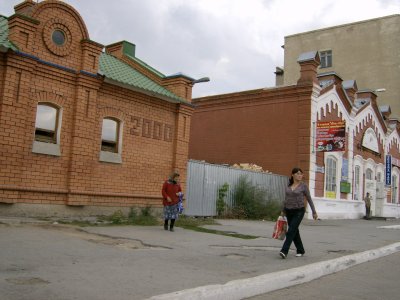 Old and new, youth and age. Brick building is public toilet, opened in 2000