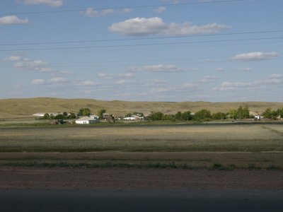 A village on the steppe with first hills I've seen for more than 100 miles