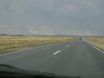 Rain in distance and recently here going by the car ahead