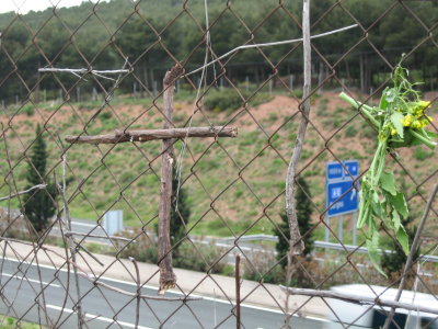 Crosses left by pilgrims on the fence
