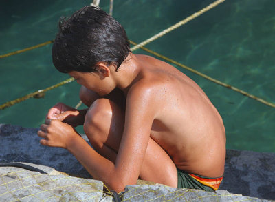 Mykonos boy by the water.jpg
