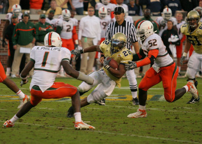 Tech TB Tashard Choice cuts between Miami defenders...