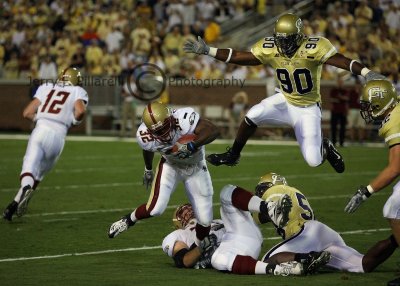 Tech DE Darrell Robertson goes airborne in pursuit of RB Andre Callender