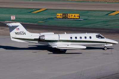 Private Learjet 35 taxiing to active RWY 25R.