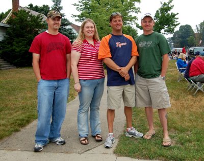 Four Robinson's standing on Robinson Corner in Newberry, 4th of July Parade. Shown left from right are: David Arthur Robinson Jr., Salena Marie [Robinson] Mann, Tom Francis, & Justin David Robinson. This same photograph can be seen in our Newberry Michigan gallery.