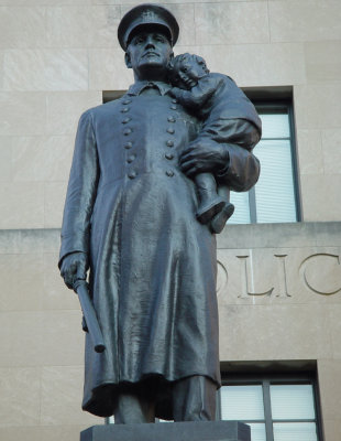 Monument on the steps of the Kansas City Missouri Police Department. One of my favorite monuments in the City. Strong police officer, protecting the young & the weak. Very, very cool.