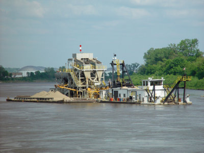 Dredging the river for sand. 