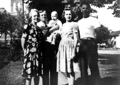 Shown above are the Mann family of Wymore Nebraska. We see from left to right: Susan Gertrude [LAWRENCE] Mann, and her husband, Thomas Morgan Mann. Thomas is holding his grandson, Lawrence Richard Wilson. Next is Lawrence's mother and the daughter of Thomas and Susan: Mary Anne [MANN] Wilson. Next to her is her brother, and the son of Thomas and Susan; Howard Thomas Mann. This shot was taken circa 1942.