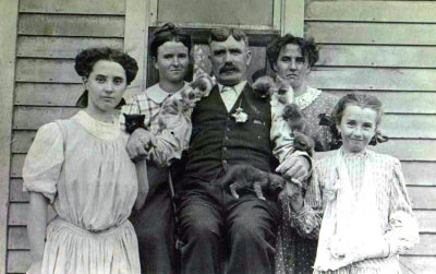 Apparently the man liked both children, & cats. This is an original photograph of William John Whiston Merrill & four of his daughters. Shown left to right are: Cora, Bessie, William, Daisy, & Ruth Merrill, taken in Crete, Saline County Nebraska circa 1910. This original photograph was given to me by my grandmother Hazel Alice Merrill. I am in possession of the original photograph. William was bon in Etobicoke, York, Ontario, Canada. He married Lillian Elizabeth T. Walker in Lincoln, Lancaster County Nebraska on 10 February 1883. Together this couple would have 12 children, the third of which was my great paternal grandfather; LeRoy Charles Merrill.