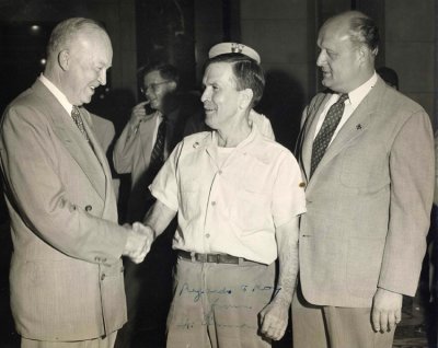 Roy Merrill was one of my paternal great grandfathers. He was also head custodian at the Nebraska Capitol Building for almost forty years. Here in this photograph we can see him shaking hands with then President Ike Eisenhower. Standing right is the then Nebraska Governor, Val Peterson. The original photograph shown was given to me by my grandmother, Hazel Alice Merrill. I am in possession of it still. This original photograph has Ike's signature attached in marker.