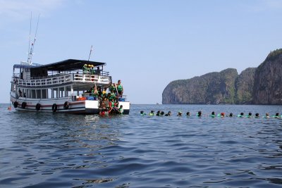 Snail of Thai tourists swimming to the Emerald Cave