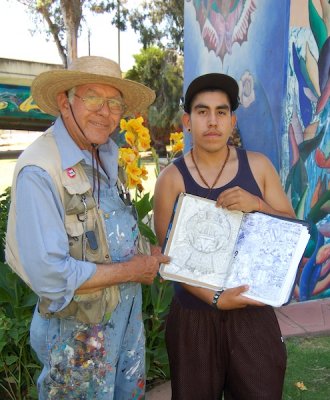 Salvador R. Torres encourages a young painter