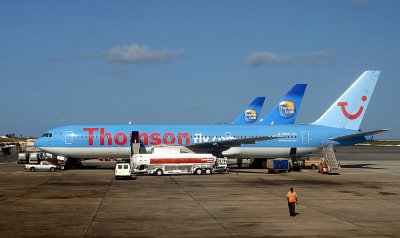 Thomson Fly 767-300 leads a line up of UK charter airliners at Barbados, Apr, 2007