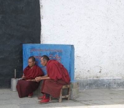 Monks sittng by the entrance of the monastery